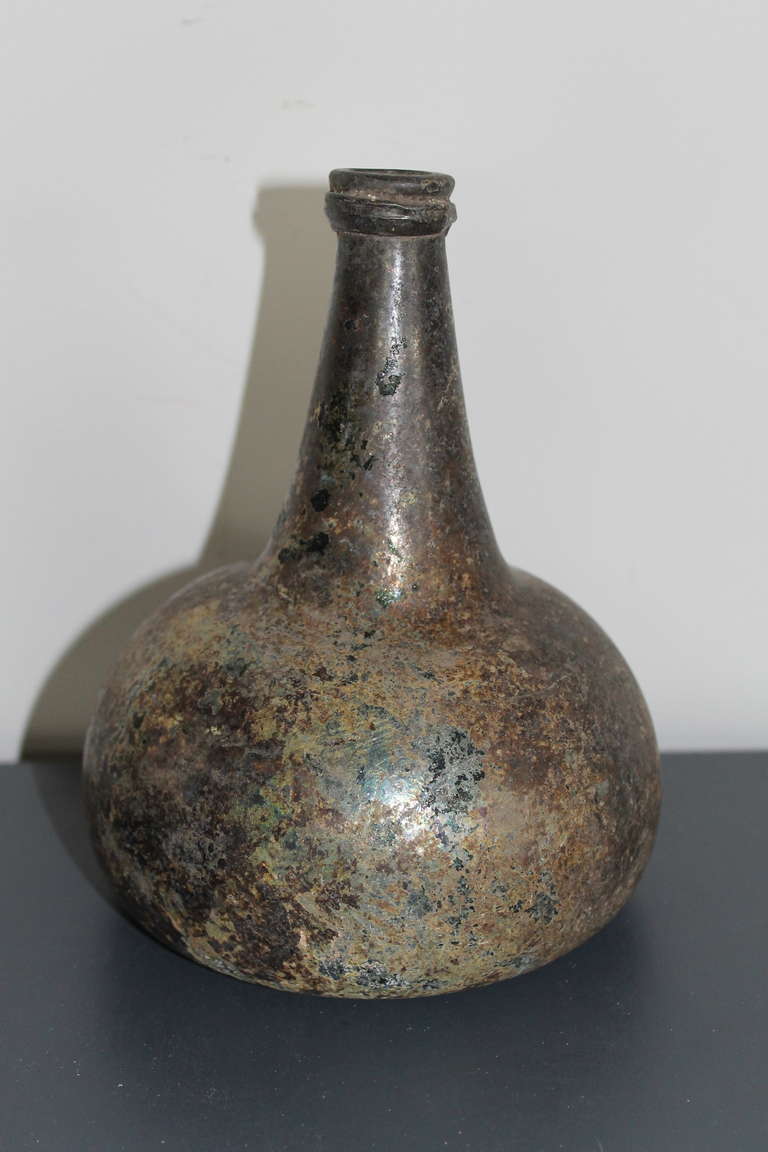 Dutch wine-bottle, irisated glass, 17th century. Found in the harber of Paramaribo, Suriname.