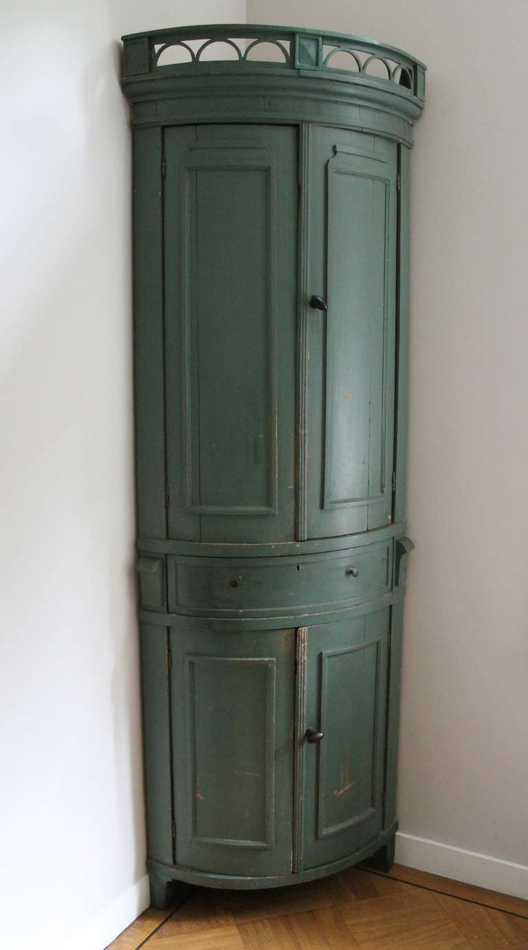 An original green painted Dutch corner cupboard, 18th century, with 4 doors and 1 drawer. The interior is red.