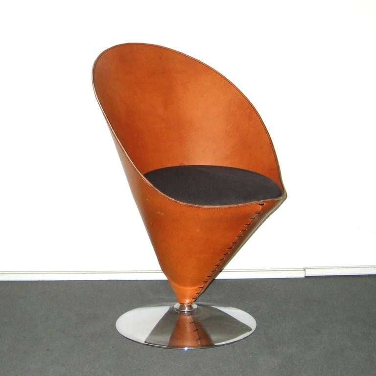 Cone chair by Verner Panton, signed with the number 38. The sculpture chair is in full grain leather and with a black upholstered seat from manufacturer Polythema.