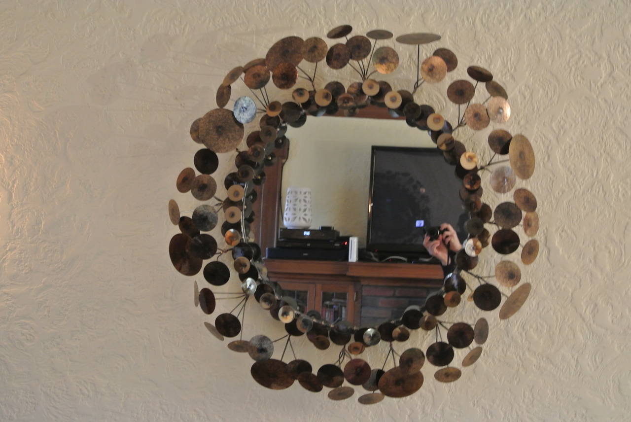 Circular Mirror with Brass and Copper welded various sized drops. 
Signed Curtis Jere