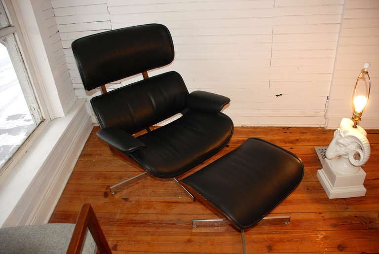Plycraft lounge chair and ottoman upholstered in new black vinyl.