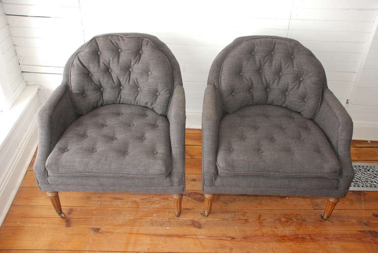 Pair of Kittinger club chairs vintage with newly recovered grey Belgian linen with solid walnut legs and metal casters.