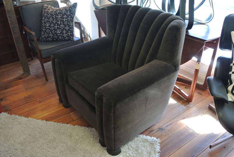 Beautiful oversized Art Deco velvet club chair with Arts and Crafts carved mahogany wooden legs.