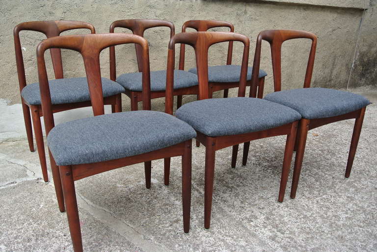 Beautiful vintage teak dining chairs by Johannes Andersen for Møbelfabrik. This set of six 