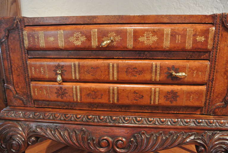 Mahogany and Egyptian brown leather Georgian ball and claw game table
with playing pieces by Maitland Smith. Checkerboard and backgammon boards and pieces; are neatly concealed inside a faux book that tucks into the base, a separate drawer is also