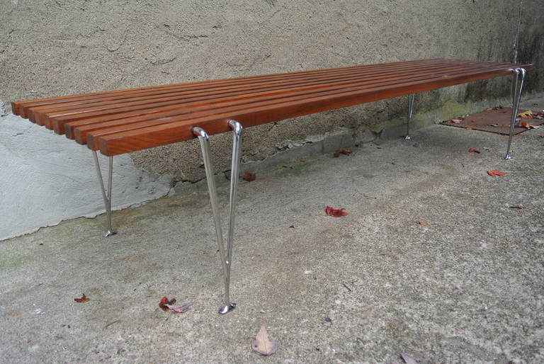 Stunning example of simple but elegant lines. Solid Walnut slats held together by individual chrome rods seamlessly welded together to create one sculpted leg.