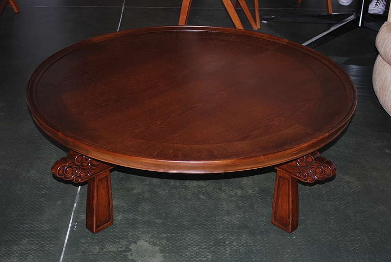 This striking mahogany Chabudai table stands on four intricately carved legs supporting a two-toned circular top. Like similar Edward Wormley designs for Dunbar and Robsjohn-Gibbings designs for Widdicomb, the table epitomizes the 1950's fusion of