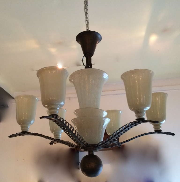 Wrought iron chandelier and sconces by Brandt, frosted glass shades by Daum signed.