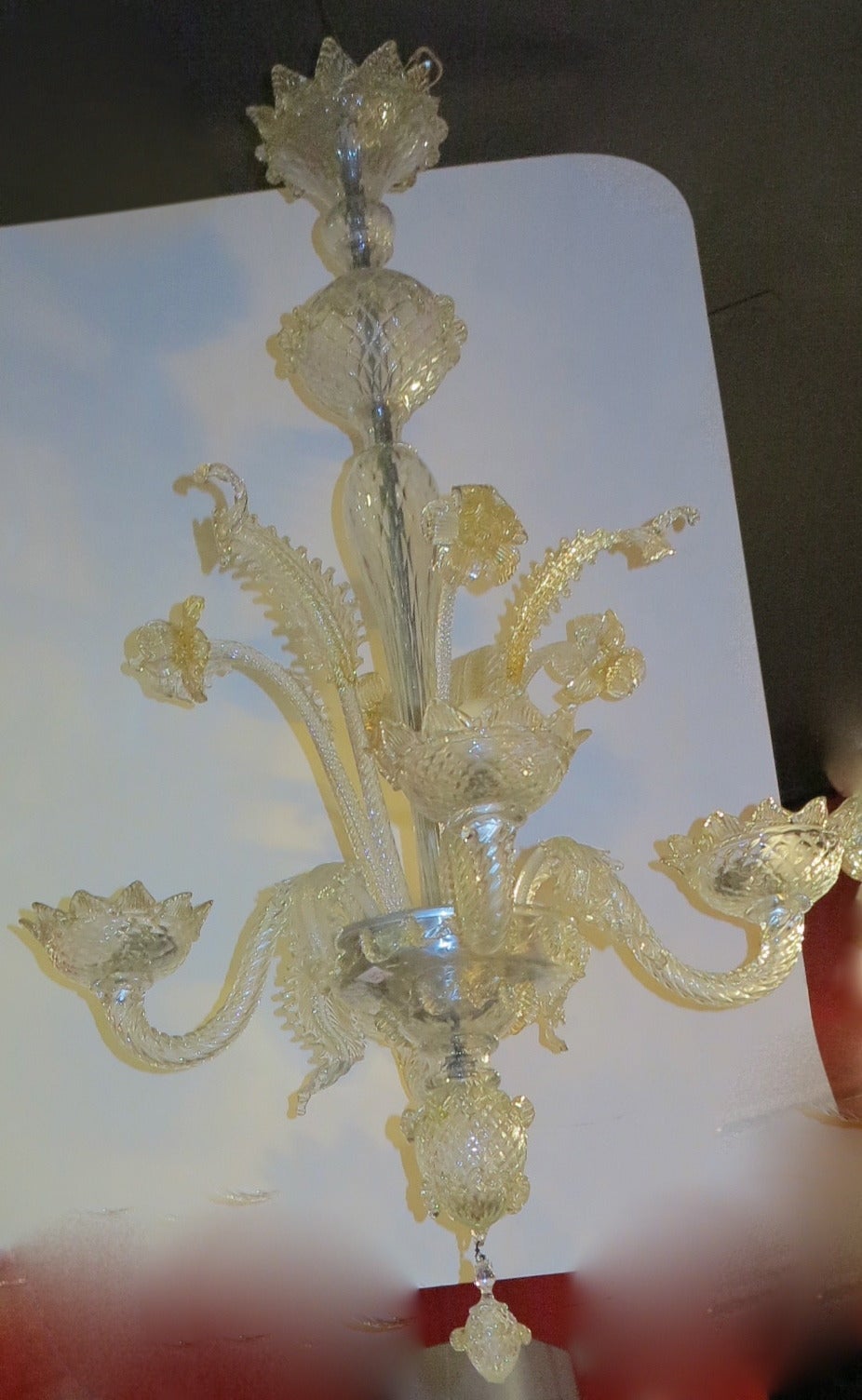 Chandelier crystal with inclusion of gold sheet good condition circa on 1950, four flowers and eight leaves. Sconces three lights arms and three flowers and eight leaves. Measures: 62 H x 50 width x 34 depth.