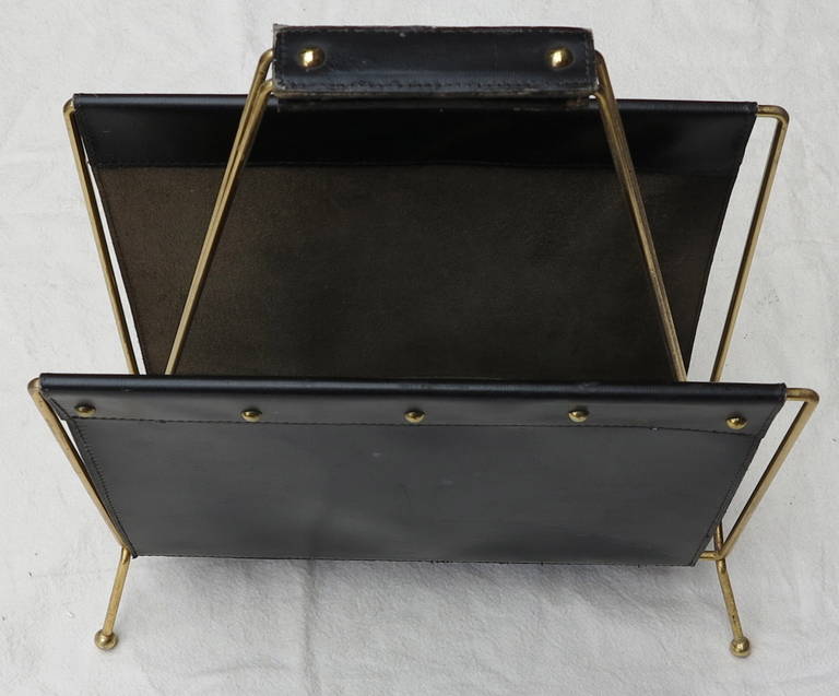 Gilt metal and stitched leather book rack, in good condition. Circa 1950-1970.