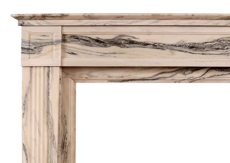 An early 19th century French Cipollino marble fireplace, with panelled frieze and side blockings. Reeded jambs and breakfront moulded shelf.

Shelf Length - 46 in / 1168 mm
Overall Height - 41.25 in / 1048 mm
Opening Height - 32.25 in / 819