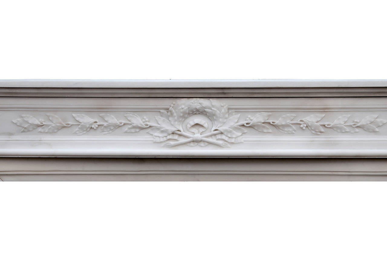 A fine quality 19th century (circa 1850) French Louis XVI style statuary marble fireplace. The shaped frieze delicately carved with laurel leaves, acanthus leaf jambs with beads, surmounted by square pateras. Breakfront shelf.

Measures: 
Shelf