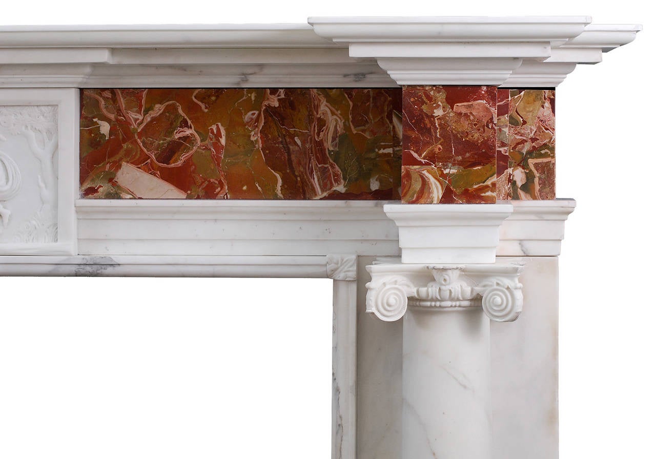 A George III style statuary and jasper marble fireplace. The full round columns surmounted by Ionic capitals. The centre tablet with classical figures, on Sicilian Jasper marble frieze. Breakfront moulded shelf above, 19th century.

Measure: 
Shelf