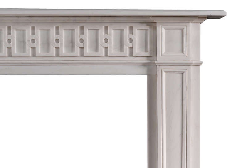 An English, Chippendale inspired white marble fireplace. The frieze (from an original drawing) of isometric design, tapering panelled jambs surmounted by panelled corner blocks. Moulded shelf.

Shelf Width: 1535 mm / 60 3/8 in
Overall Height: 1220