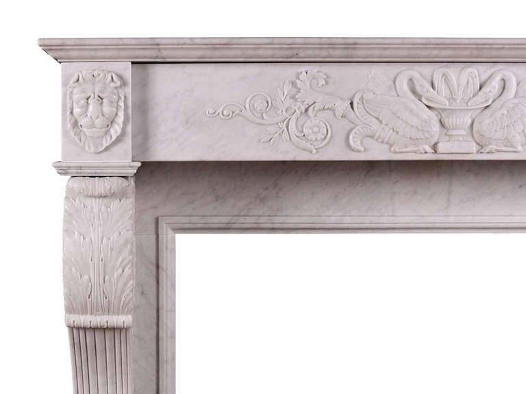 A 19th century Italian marble fireplace in Carrara marble. The finely carved frieze with classical scene depicting swans drinking from urn fountain. The shaped jambs with lion's paw feet, surmounted by acanthus leaves, with fine carving to sides.