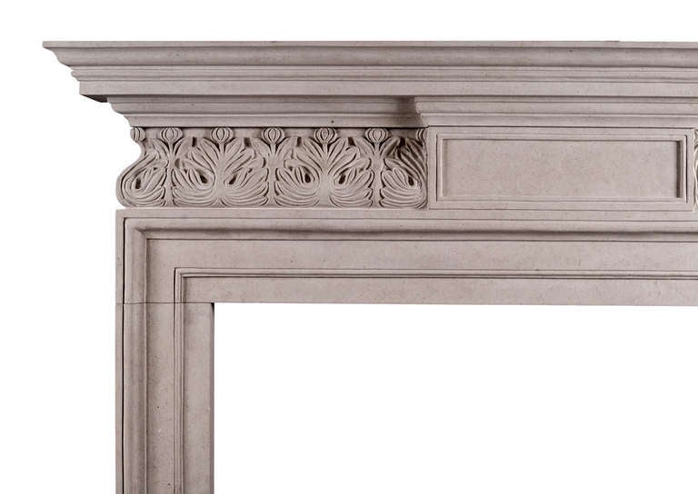 An elegant English George II style fireplace in Portland stone. The carved frieze with leaf motif and moulded centre panel, surmounted by moulded shelf. A fine quality copy of a period piece.

Measure:
Shelf Width:	1535 mm      	60 3/8 in
Overall