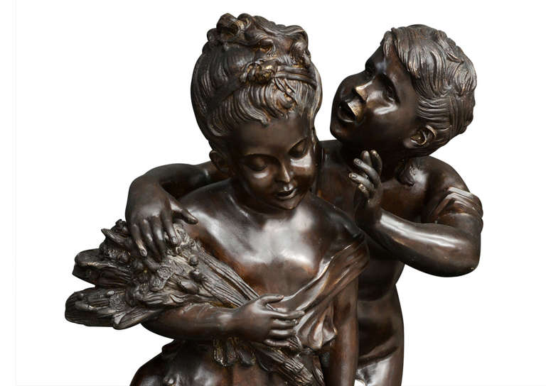 A mid 19th century bronze casting of classical boy and girl. The girl holding a sheaf of wheat, the base decorated with foliage. Titled 