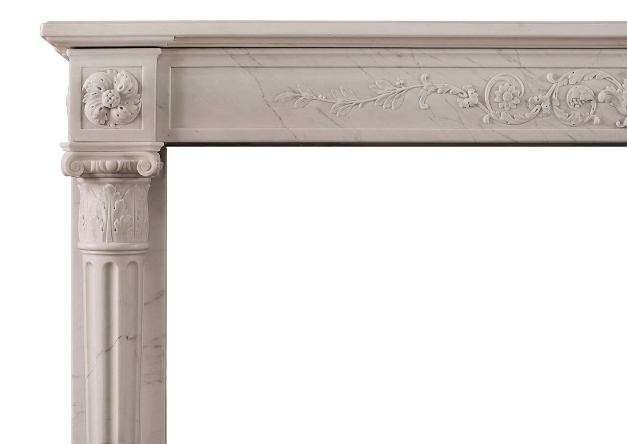 A particularly fine quality late 18th French Louis XVI Statuary marble fireplace. The frieze delicately carved with leaves and foliage, full round tapered and carved columns to jambs, with acanthus leaved and ionic capitals, surmounted by carved