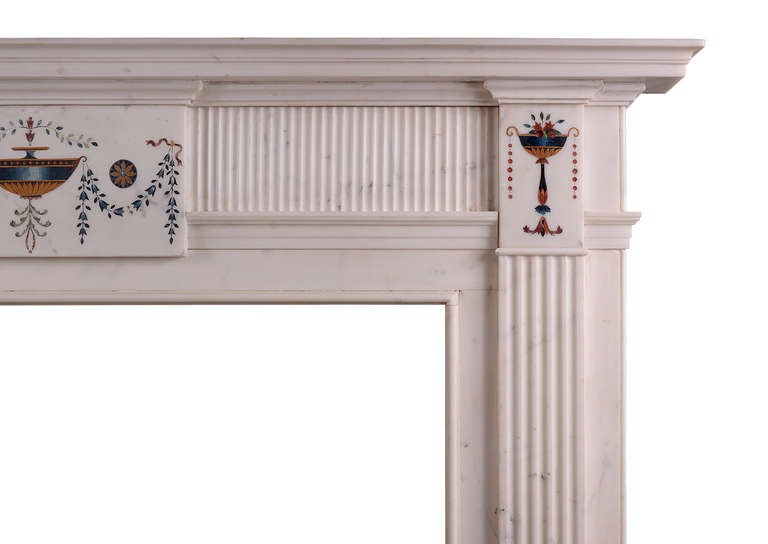 A fine Irish veined statuary marble fireplace. The richly coloured inlaid centre tablet and side blockings in the manner of Pietro Bossi, with urns, bellflowers and foliage. Fluting to jambs and frieze, surmounted by moulded shelf, early 19th