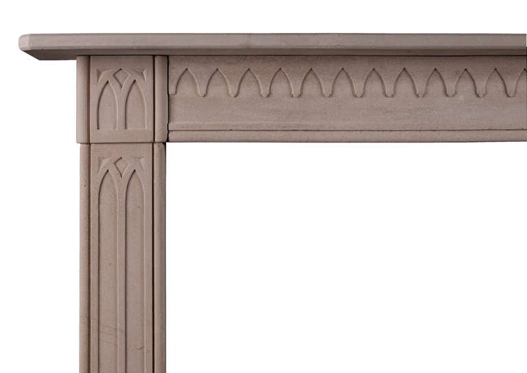 A 19th century English limestone fireplace in the Gothic manner. The jambs and end blocks with Quinto acuto arches, the frieze with accompanying arch motif throughout with shelf above, circa 1830.

Measures: 
Shelf Width:	1480 mm      	58 1/4