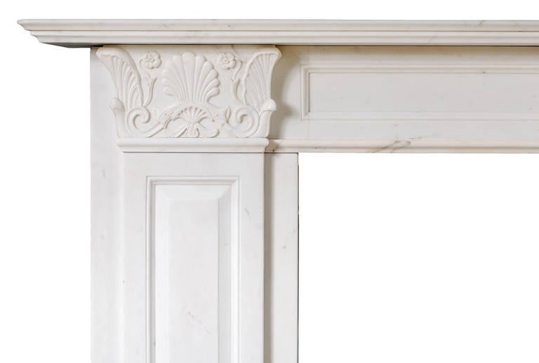 A 19th century statuary Regency marble fireplace in the manner of Thomas Hope. The side blockings depicting scrolling, leaves, shells and flowers. Raised and fielded panelled jambs.

Shelf width - 1830 mm - 72 in
Overall height - 1145 mm - 45 1/8