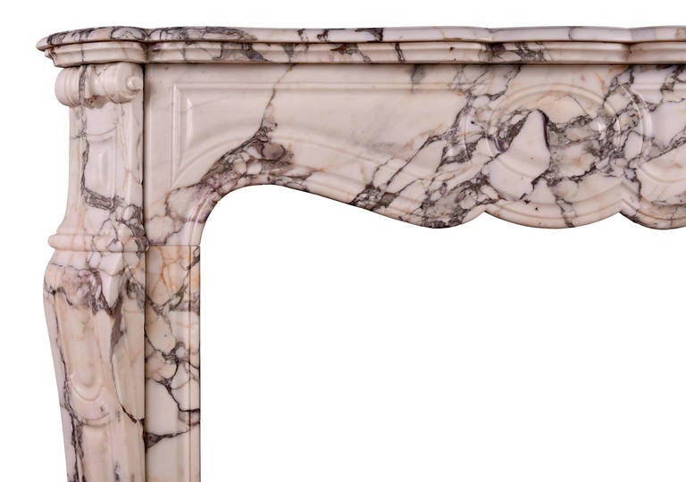 A petite 19th century French fireplace in Breche Violette. The shaped, panelled jambs surmounted by scrollwork, the panelled frieze surmounted by shaped, moulded shelf. Very fine quality Breche Violette marble. 

Shelf width - 1245 mm / 49
