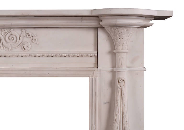 A fine quality period Regency carved statuary marble fireplace in the manner of Thomas Hope. The jambs in the form of neoclassical torchers decorated with acanthus. The frieze centred by an acanthus flanked by foliate scrolls. Reeded and ribboned