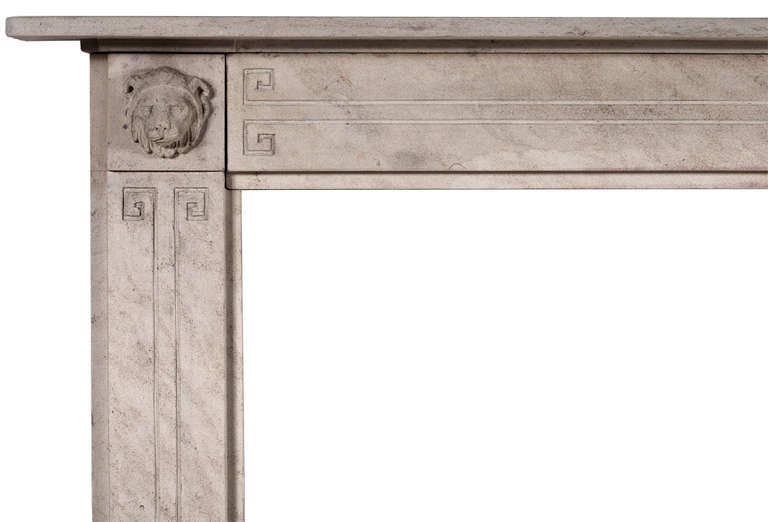 An attractive period English Regency limestone fireplace. The jambs and frieze with Greek key motif, the end blockings with carved lion's masks with moulded shelf above. Early 19th century.

Measures: 
Shelf Width:	1525 mm      	60 in
Overall