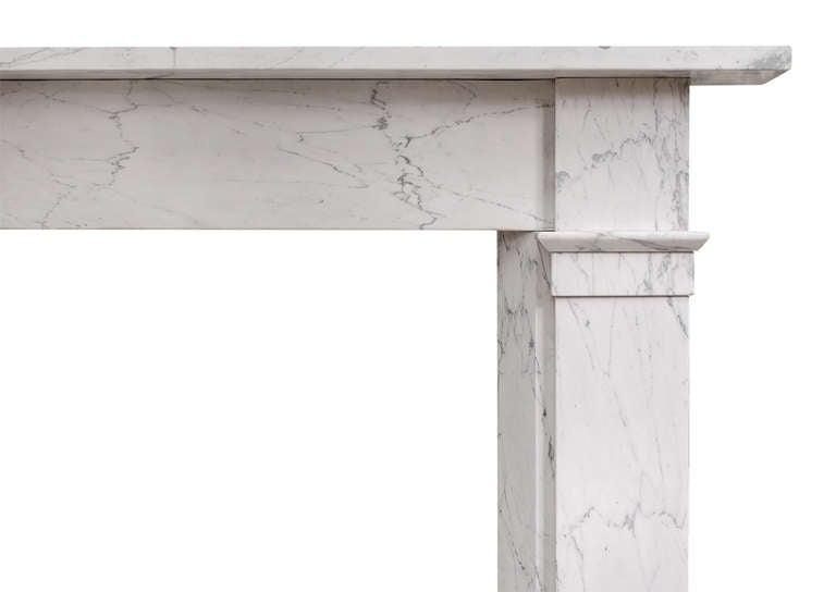 A well proportioned mid 19th century English fireplace in veined Statuary marble. The flat jambs with angled ingrounds, surmounted by moulding and plain end blockings. Plain frieze and shelf.

Shelf Length - 66.25 in / 1683 mm
Overall Height -