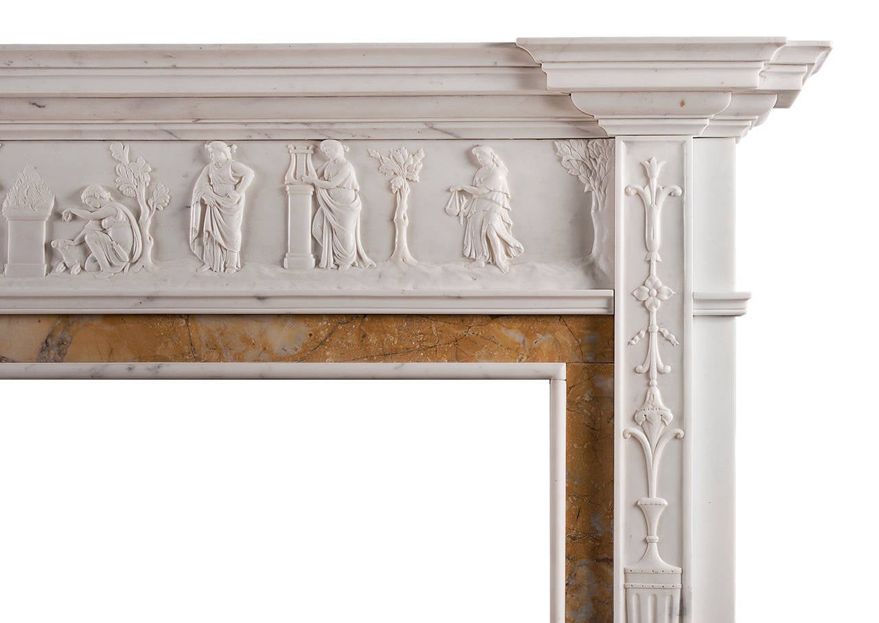 A very fine period neoclassical English Statuary marble fireplace with Siena inlay. The carved jambs with classical urn surmounted by ribbons and drapery, with Siena marble ingrounds. The carved frieze with classical figures throughout. Breakfront