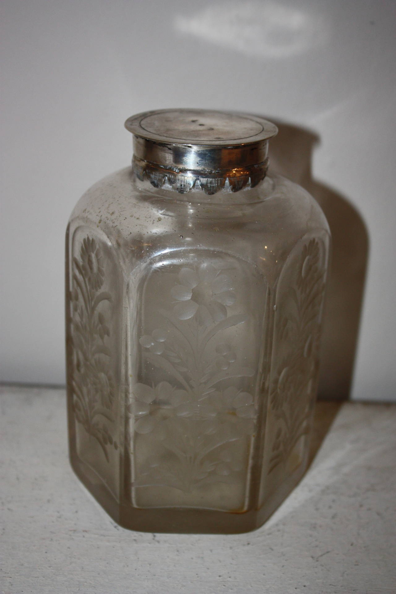 Very beautiful glass bottle with silver lid and engraved flower motives.