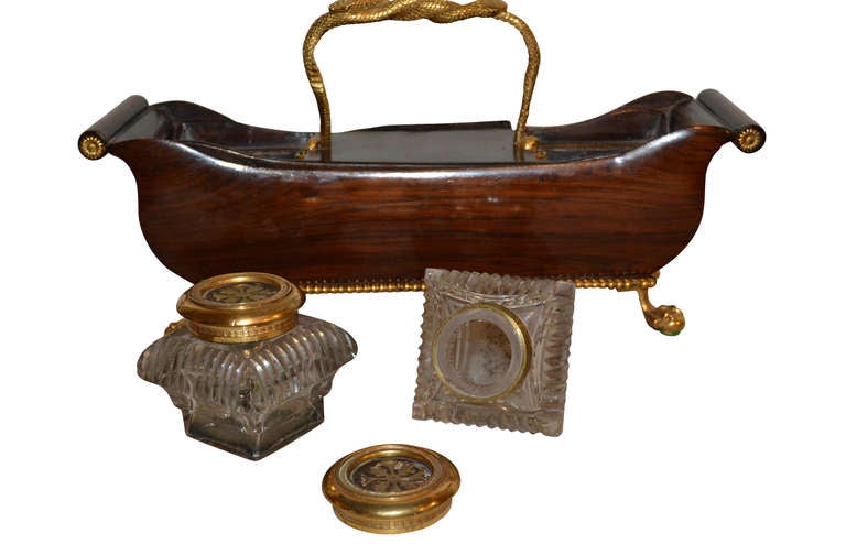 French cut-glass, Palisander and ormolu inkwell. Sneaks as handle and claw on ball feet. Original glass wells and two drawers.