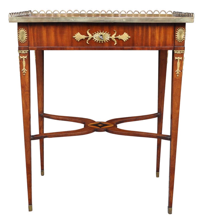 Small early 19th century mahogany brass and gilt bronze mounted writing desk or table. The top Bureau Plat is inlaid with fan and border of satinwood, front drawer has divided compartments.