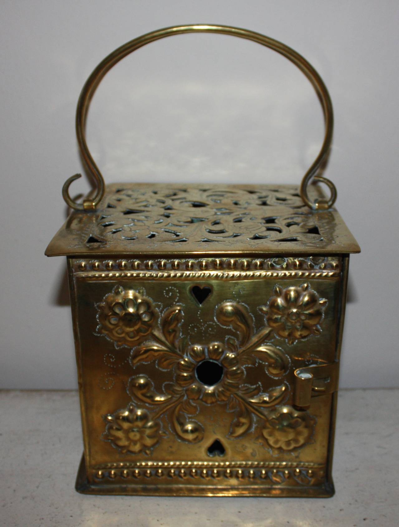 Fantastic brass footwarmer or lantern, used to bring to church so that one could keep warm in the rather cold churches at the time. But could be used with a candle and be a very decorative lantern.