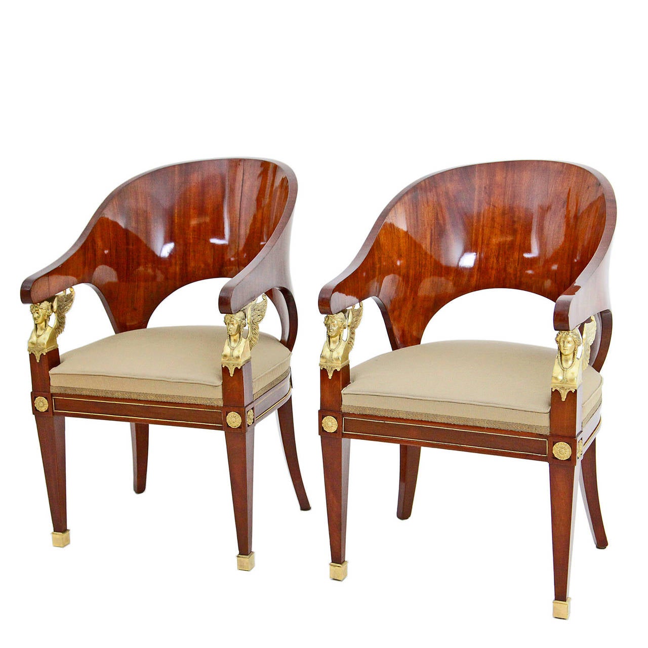 A pair of stunning Empire Russian armchairs, dating from the early 19th century.
Decorated with winged Karyatid-Herma.
Mahogany veneer and finest bronze mounts.

The last picture shows the chair before restoration.