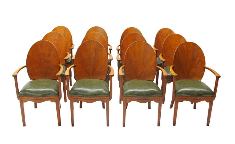 Beautiful ensemble of 12 Art Déco dining chairs and a dining table from Brussels dating from the 1930s.
Dimensions of the table: HxWxD: 29.1 x 119.7 x 62.2 inches.  
Dimensions of the Armchairs: HxWxD: 40.8 (21.3) x 24.8 x 24 inches.