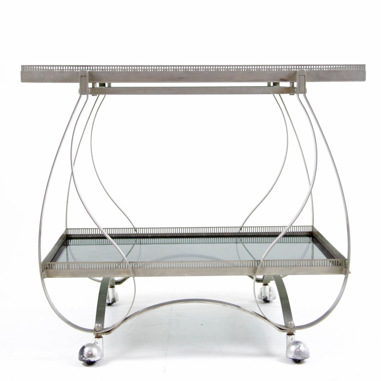 Serving trolley out of iron and with two shelves with a low railing. The framework consists of artfully curved metal ribbons that end on four rolls. 

HxWxD: 25.6 x 29.1 x 19.3 inches..