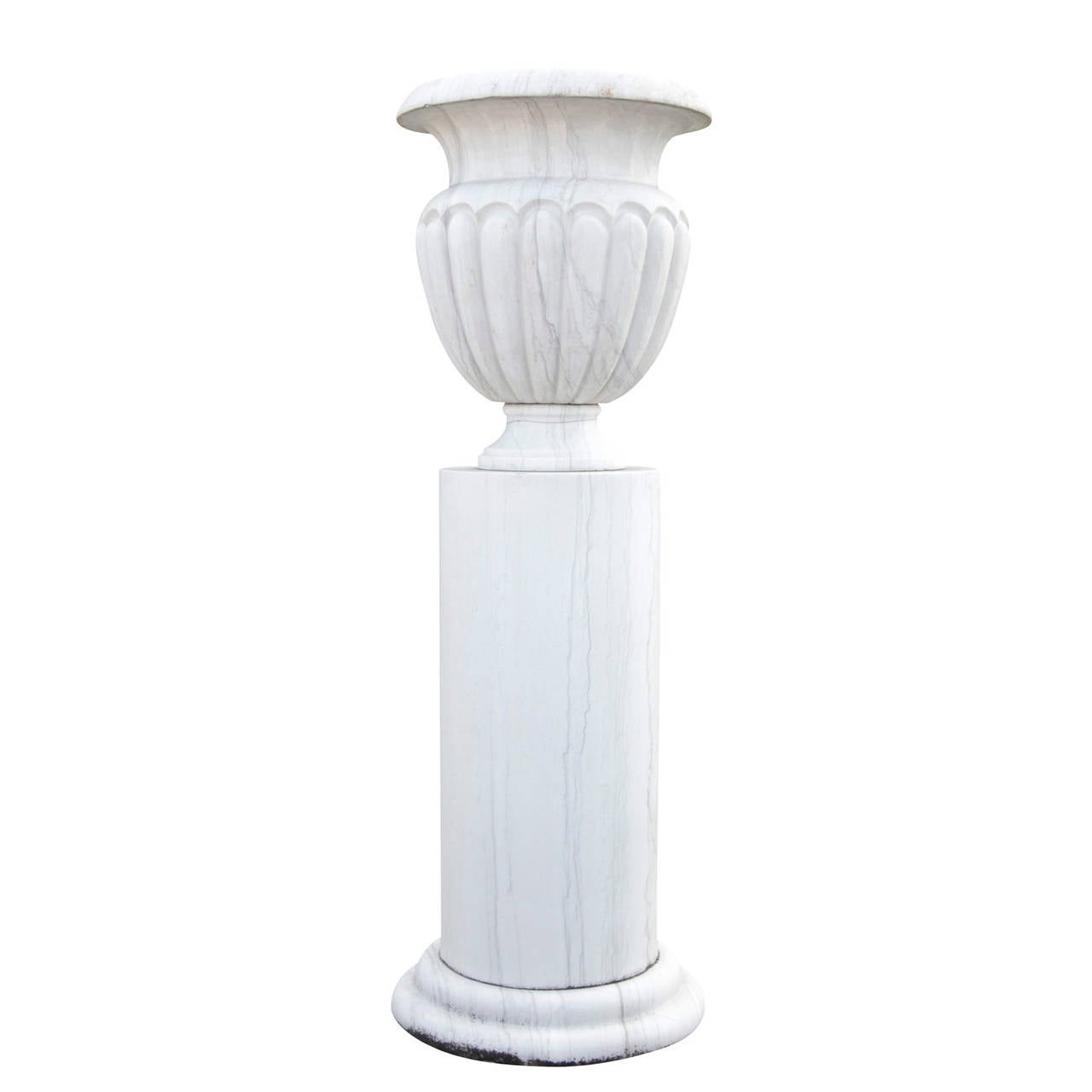 Pair Monumental Marble Park Vases with pedestals from the 20th Century. The vases are hammered by hand and have a attic base with a smooth Monolith column shaft. The vases are shaped like an antique column crater. The Body is tapered towards the