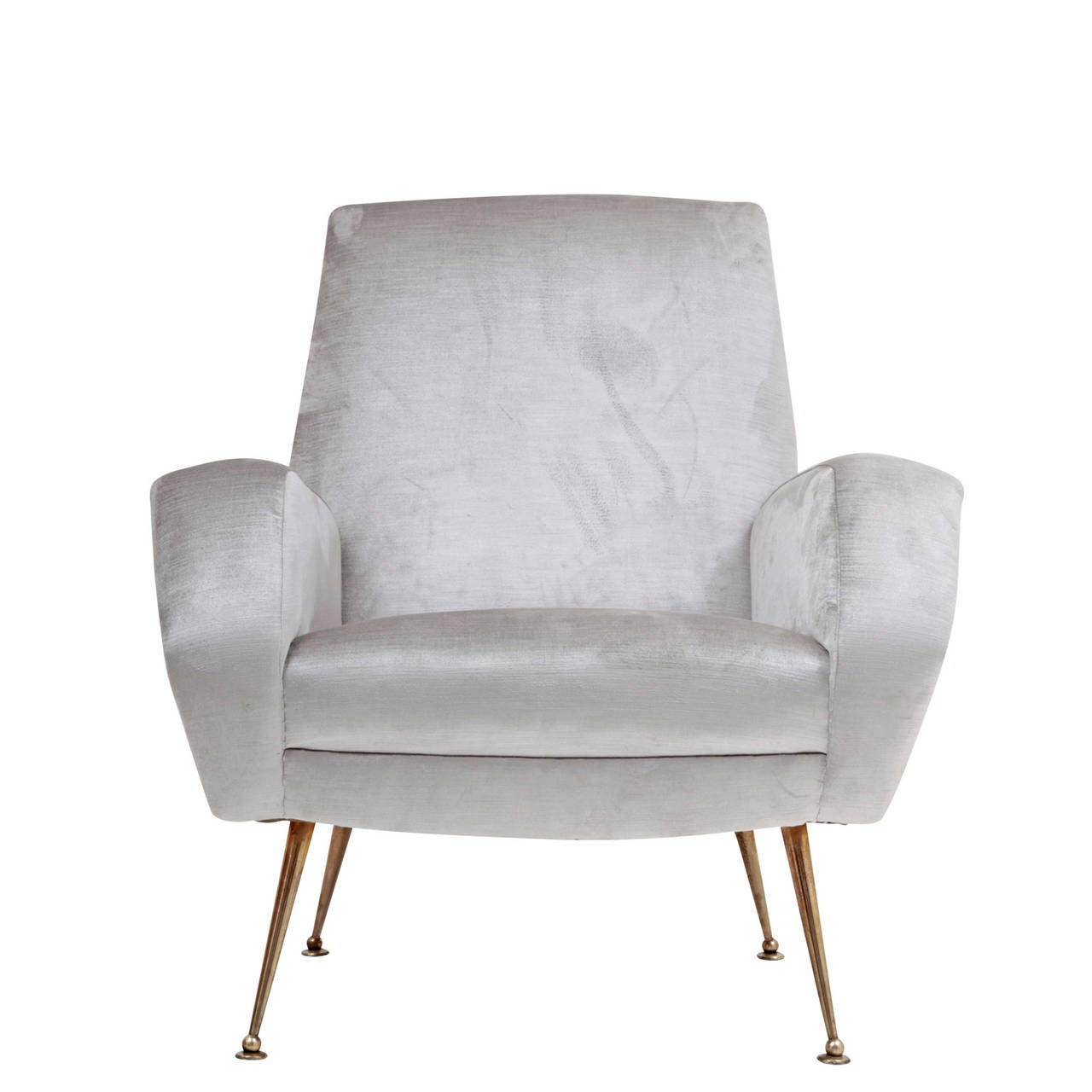 Very nice Italian Armchair from the 1970s. The chair stands on four conical tapered legs with a silvery upholstery. The legs end in ball feet on a round disc. The backrest, seat and armrests are very prominent and contrast intriguingly with its thin