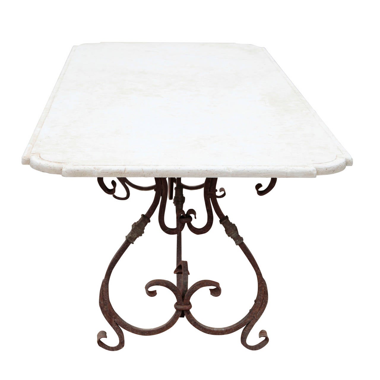 Garden table with wrought iron legs and a stone table top with curved corners.