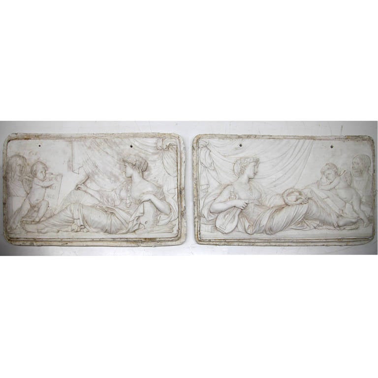 Decorative pair of French plaster reliefs dating back to 1890. The fine crafted reliefs are in good unchanged condition and have a natural patina.