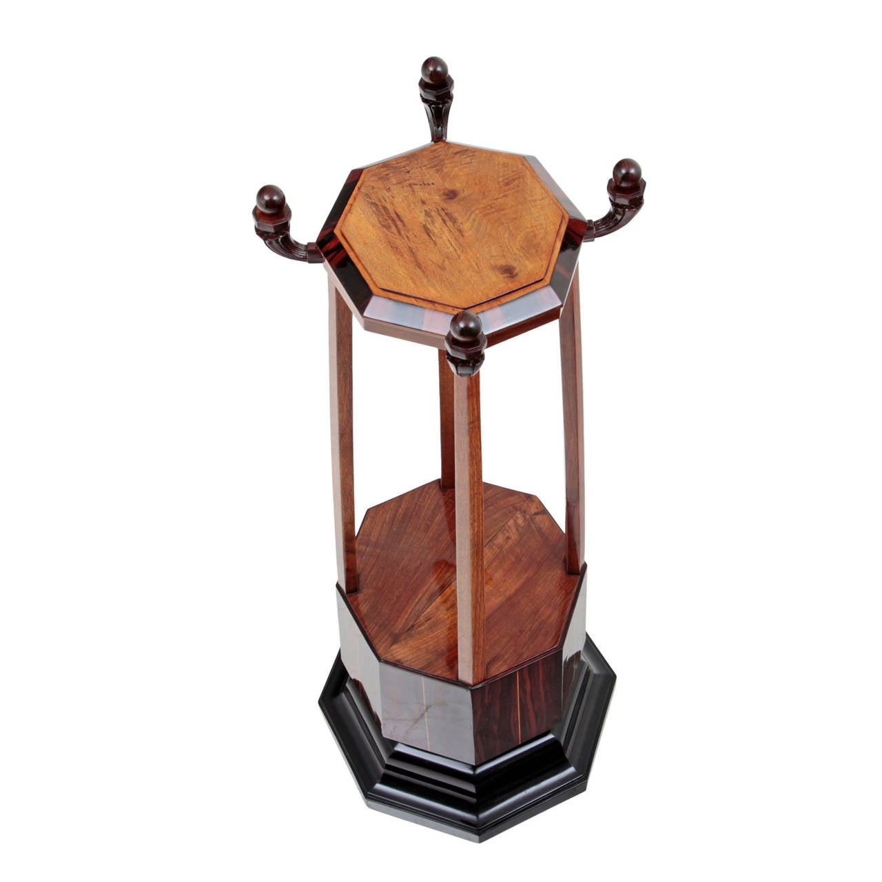 Lovely French Art Deco Pillar from the 1920s.
The octagonal Art Deco column is made out of rosewood and stands on a profiled, ebonized foot with a short and likewise octagonal shaft and a drum-shaped middle part. Over it are four long pentagonal