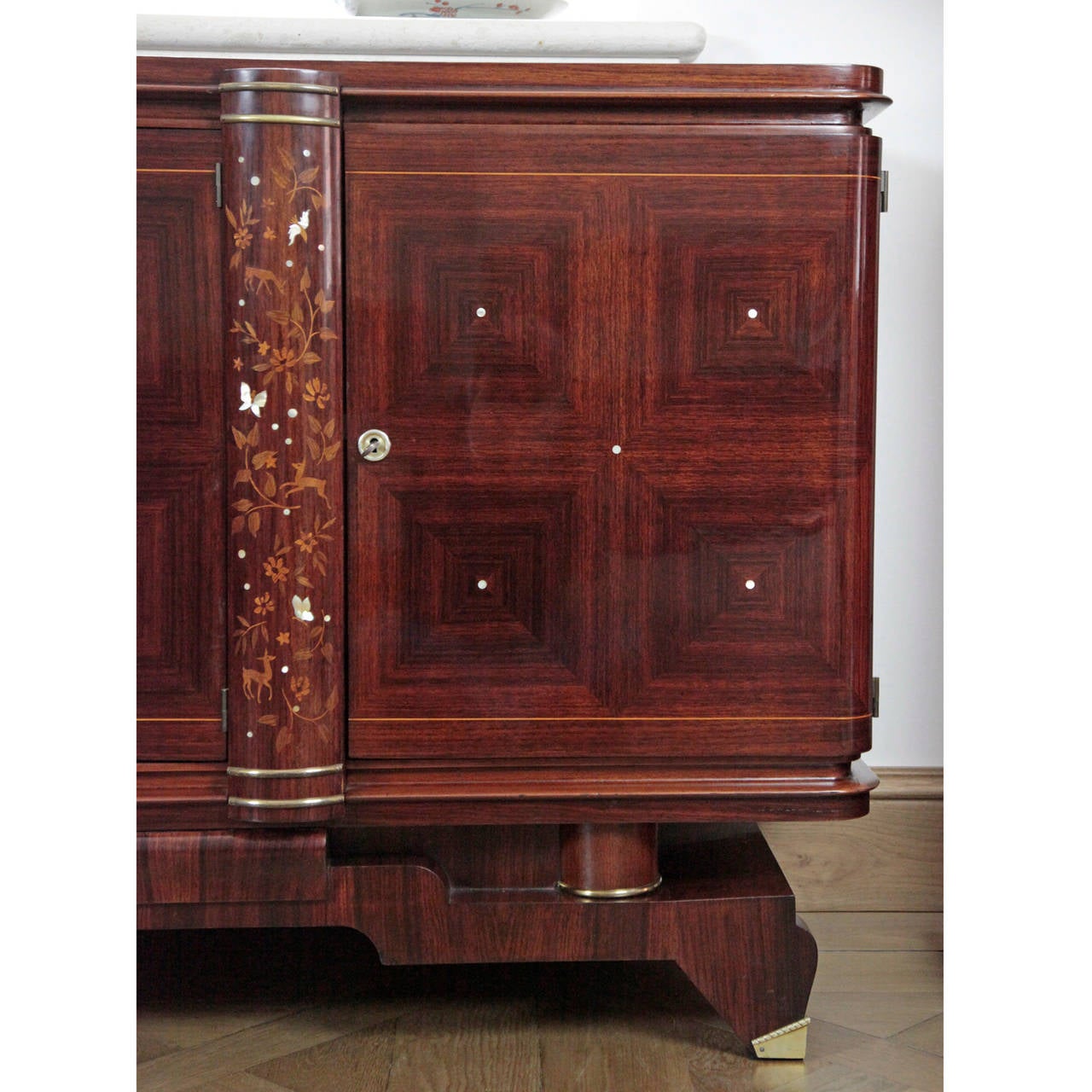 Wonderful French Art Deco Sideboard in Style of Leleu from the 1920s.
The very unusual rosewood sideboard stands on four feet and has a unique base frame with brass details. The cross rectangular long corpus has three compartments, the side parts