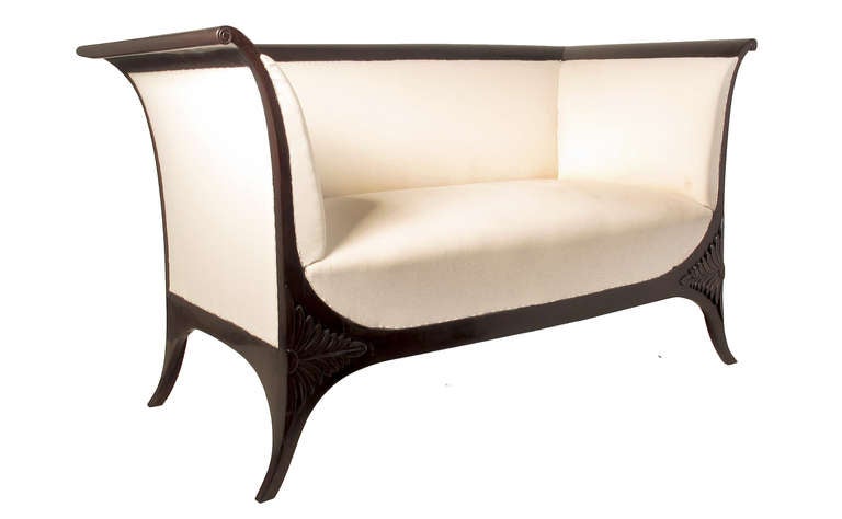 An elegant early Central German Biedermeier sofa from 1810 made from ebonized pear wood and of fine delicate shape with decent foliage and volute shaped armrests. Final textile can be chosen individually.