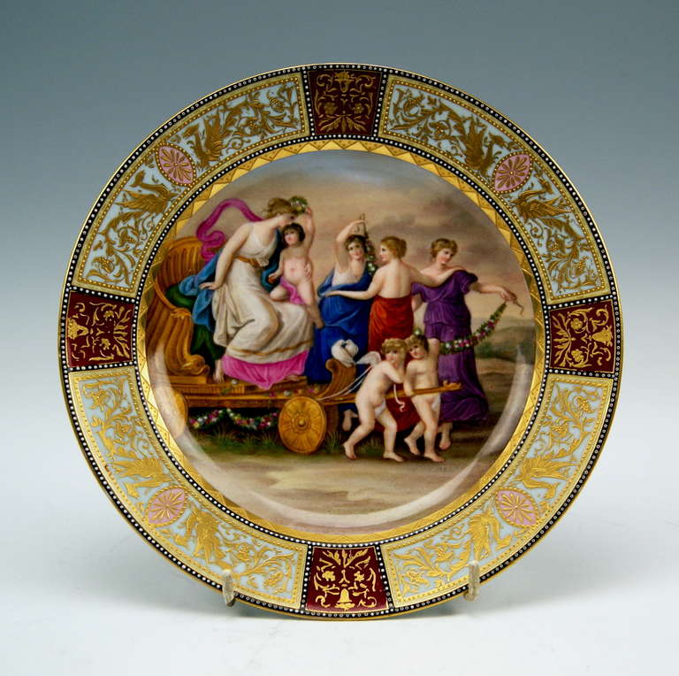 Gorgeous Meissen Plate decorated with stunning painting in middle area: The Triumphal Procession of Roman Goddess of Love - VENUS - is presented here. Venus, being situated in a chariot pulled by a pair of cherubs, caresses a boyish cherub kneeling