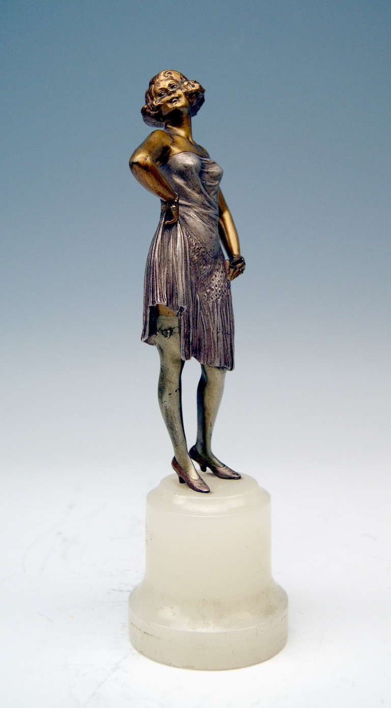A finest Viennese Art Deco Period Bronze / Lady Figurine designed by famous modeller Bruno Zach  (1891 - 1935): The lady  - holding a cigarette in left hand - wears elegant dinner-cum-cocktail-dress as well as high-heeled shoes. Painting as well as
