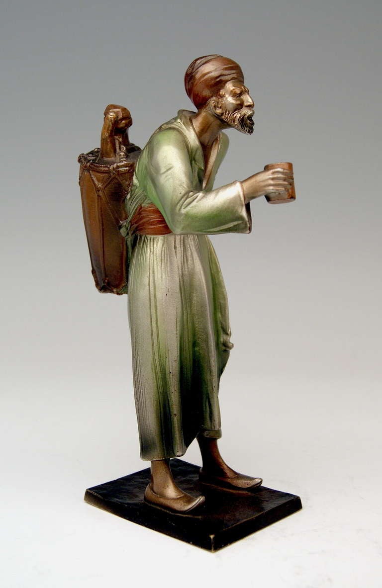 A finest Viennese Art Nouveau Bronze / Arab man designed by famous modeller Bruno Zach  (1891 - 1935): The Arab - selling water held in a vat attached to man's back - presents a drinking cup. The figurine is screwed on flat bronze base - SIGNED AT