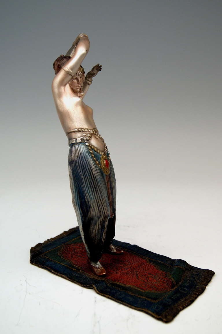 A finest Viennese Art Nouveau Bronze / Arab bare-breasted woman designed by famous modeller Bruno Zach (1891 - 1935): This Arab woman of remarkable beauty - being based on Persian carpet - plays tambourine. The figurine is screwed on the carpet -