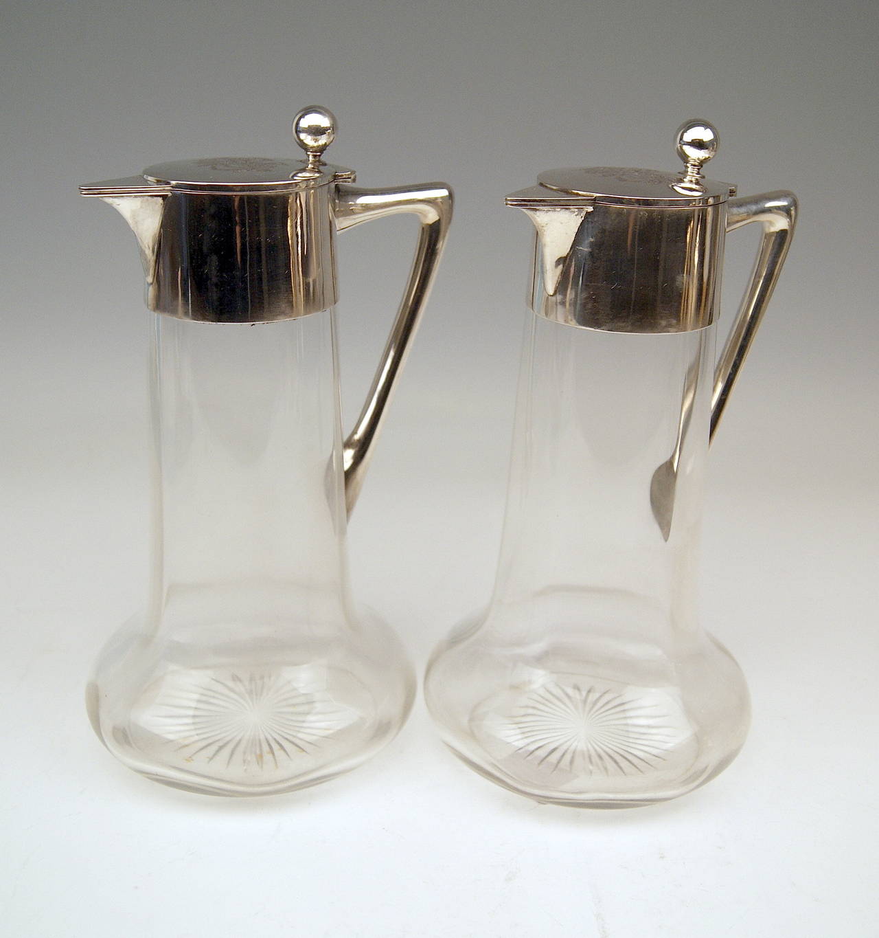 Silver German Pair of Glass Decanters / Carafes with Silver Mounting 
Art Nouveau Period  /  made circa 1900 

These carafes / decanters are of most elegant appearance:
The hollow parts made of glass - they are of very slight tapering type -
