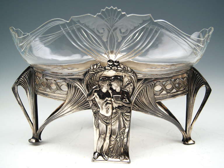 SUPERB WMF ART NOUVEAU FLOWER DISH / JARDINIÉRE  (SILVER-PLATED)  with ORIGINAL GLASS LINER 
 The flower dish stands on four feet: The silver-plated part is decorated with most elegant Art Nouveau ornaments of abstract type (parts of bowl are